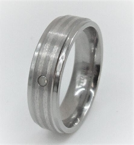 Genuine diamond set in a titanium band with silver inlay around the band