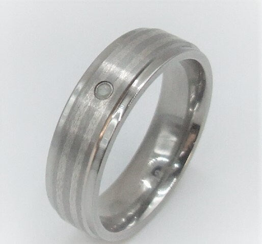 Genuine diamond set in a titanium band with silver inlay around the band