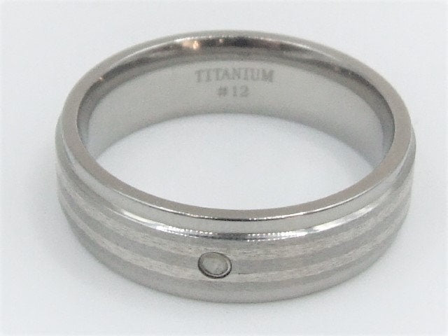 Genuine diamond set in a titanium band with silver inlay around the band